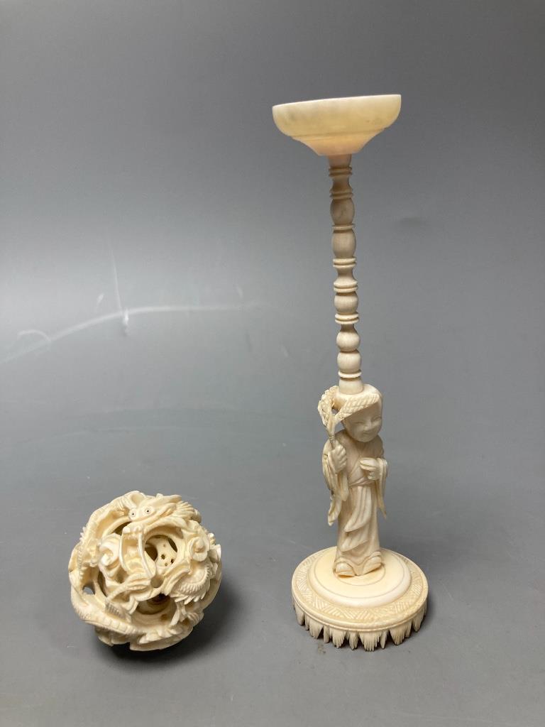 A carved Chinese ball on stand, a brise fan and a Japanese carved figure